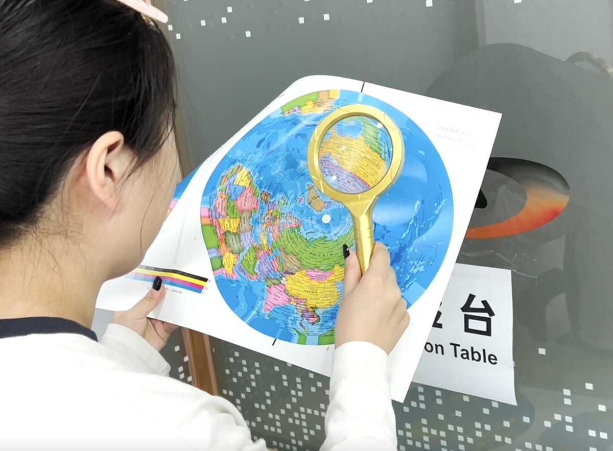 Checking a printed map proof with a magnifier